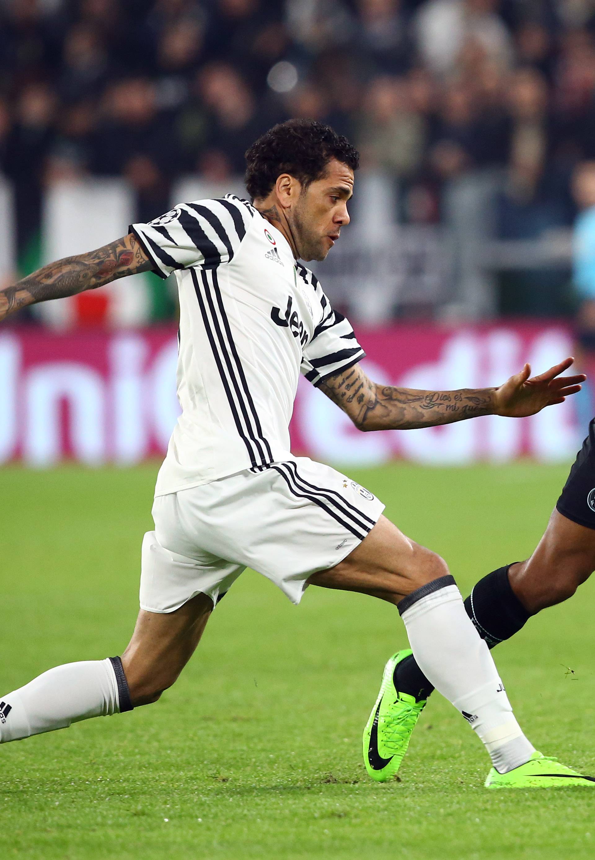 Juventus' Dani Alves in action with FC Porto's Yacine Brahimi