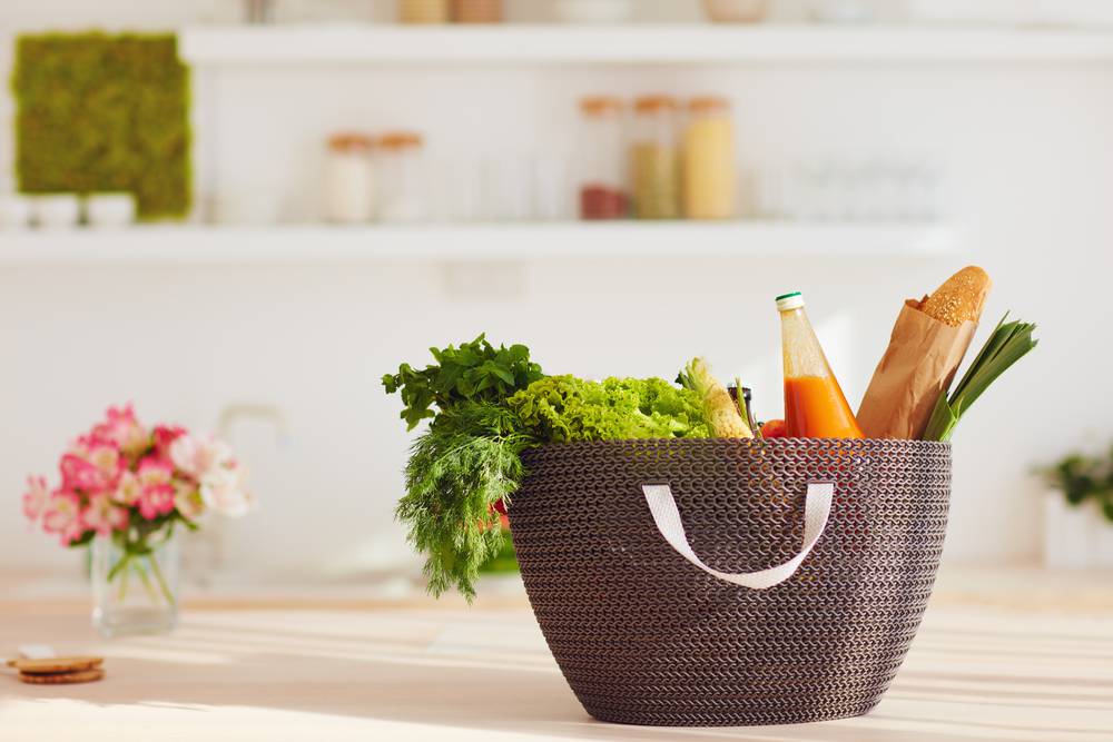 Shopping,Bag,Full,Of,Fresh,Food,On,Kitchen,Desk