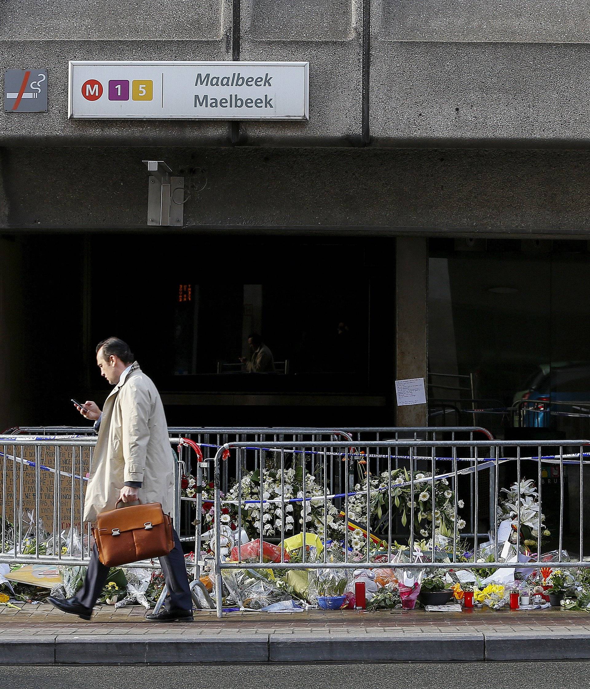 A man walks past a street memorial outside Maelbeek metro station, a week after bomb attacks took place in the metro and at the Belgian international airport of Zaventem, in Brussels, Belgium