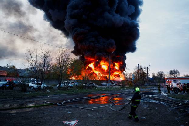 Rescuers work at the site of a Russian missile strike, amid Russia's attack on Ukraine, in Kyiv
