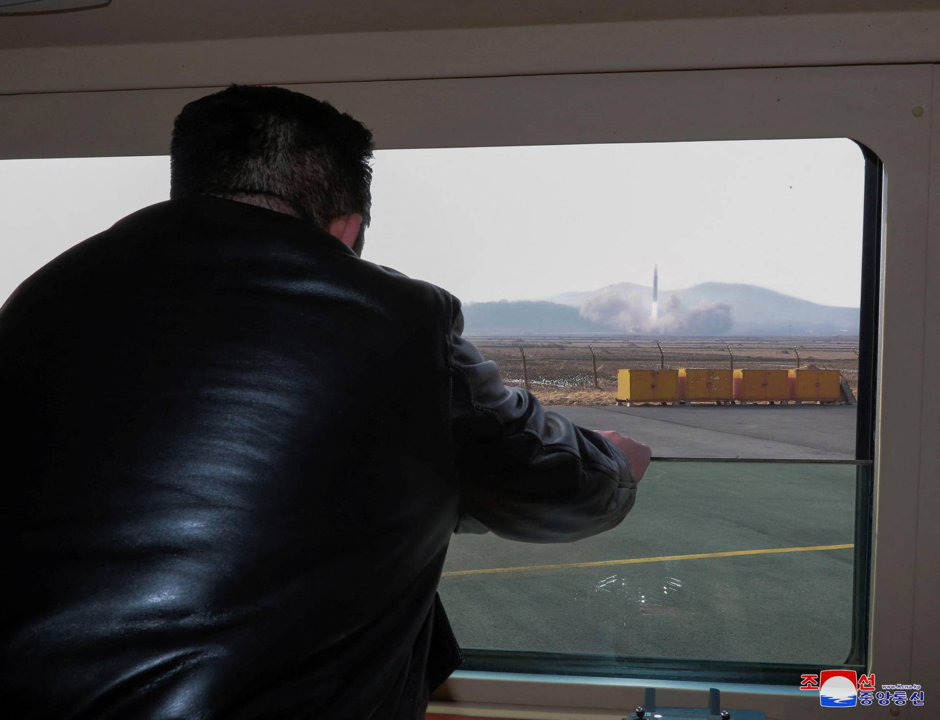 North Korean leader Kim Jong Un looks through a window during the test firing of what state media report is a "new type" of intercontinental ballistic missile (ICBM)