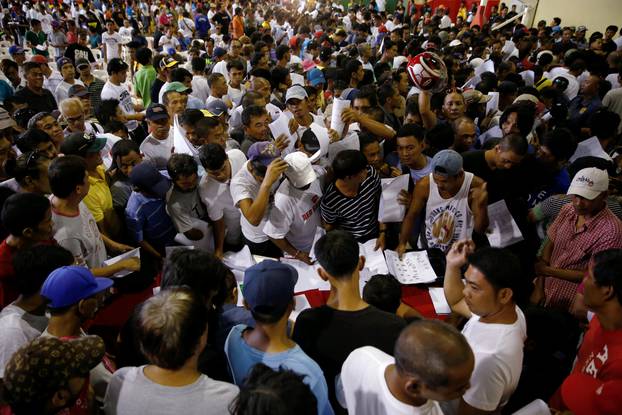 Drug users and pushers take part in a government campaign against drug as they surrender to local officials in Tanauan Batangas, south of Manila