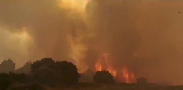 Smoke billows from a wildfire near Cuglieri