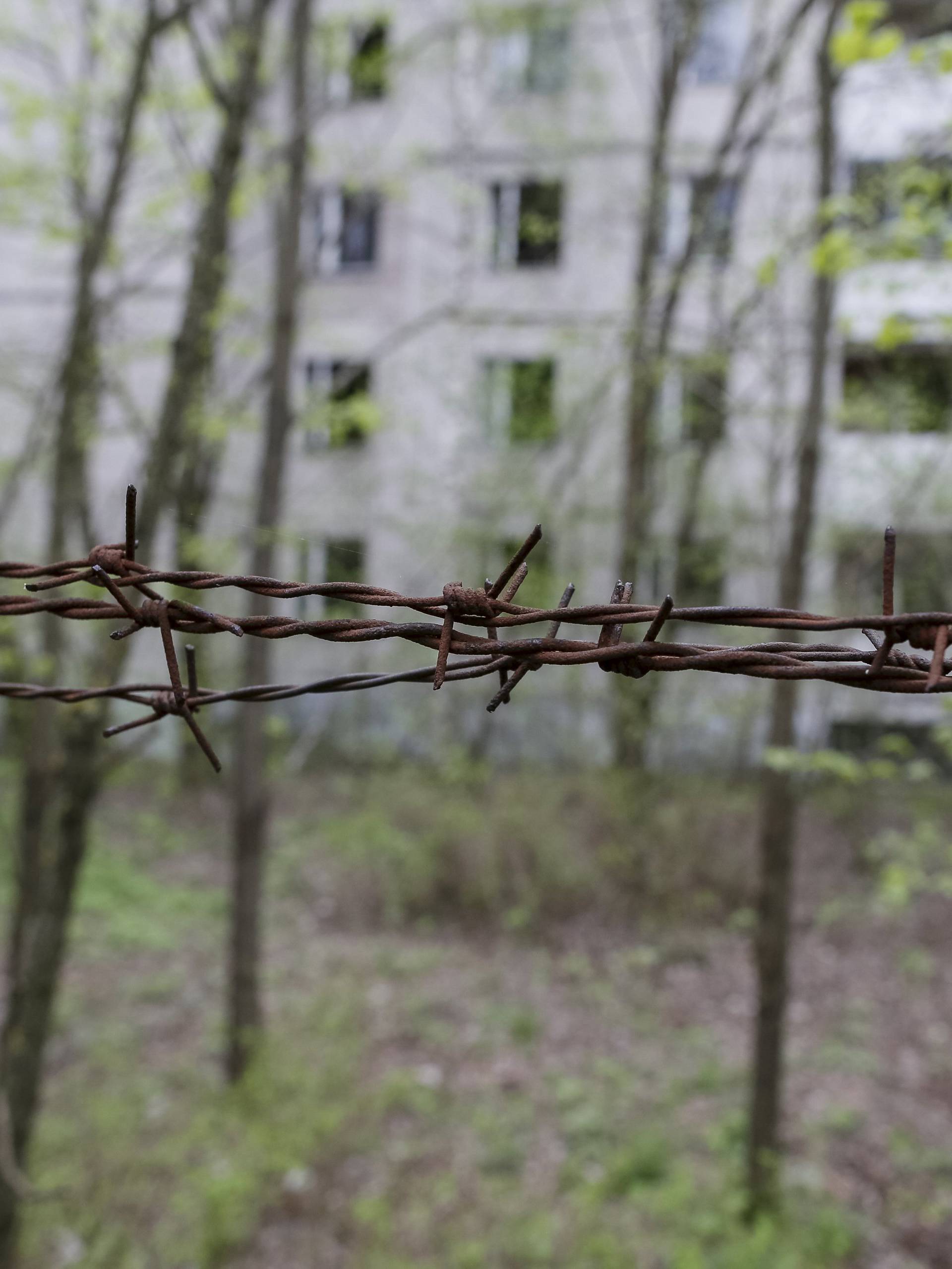 Barbed wire is seen surrounding a building in the abandoned city of Pripyat near the Chernobyl nuclear power plant