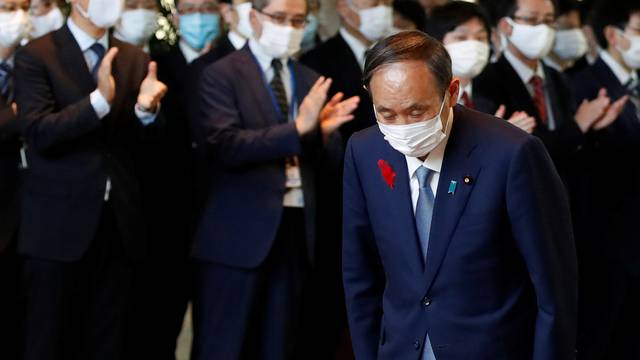 Japan's outgoing Prime Minister Suga leaves the prime minister's office in Tokyo