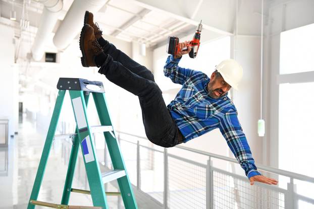Hispanic,Worker,Falling,From,Ladder,Inside,Building