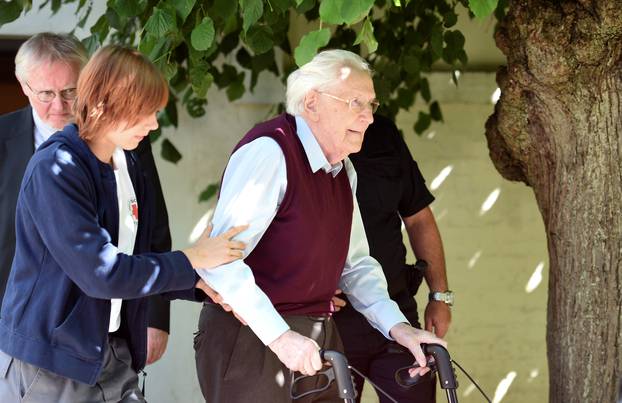 FILE PHOTO: Groening, defendant and former Nazi SS officer dubbed the "bookkeeper of Auschwitz" leaves the court after the announcement of his verdict in Lueneburg