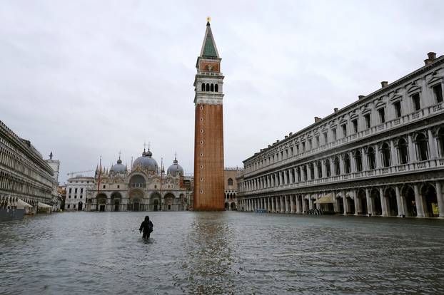 A person walks in flooded St. Mark