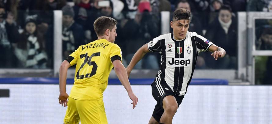 Juventus' Paulo Dybala in action with Dinamo Zagreb's Bojan Knezevic