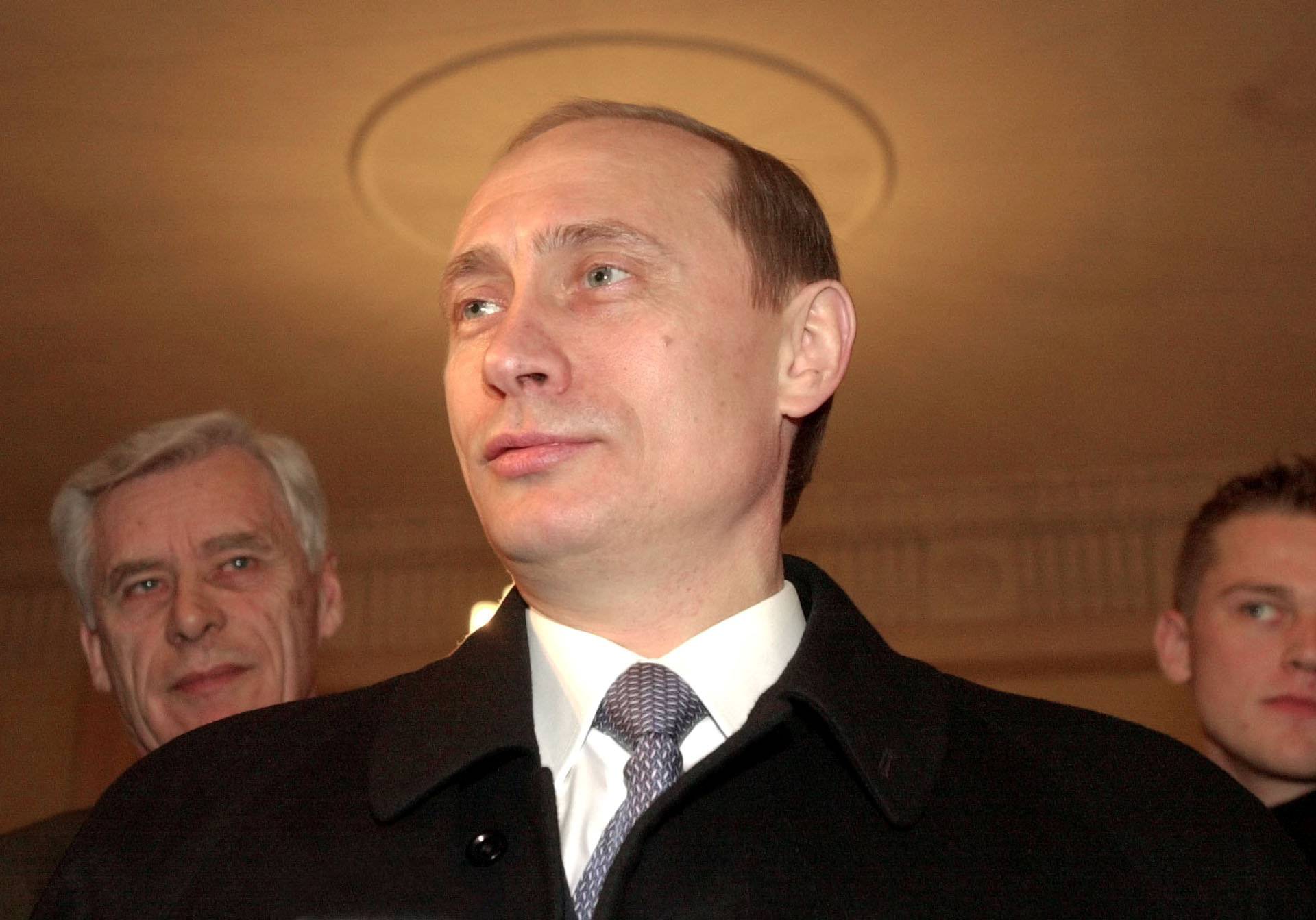 FILE PHOTO: Russia's acting President Vladimir Putin talks to the media at a polling station in Moscow