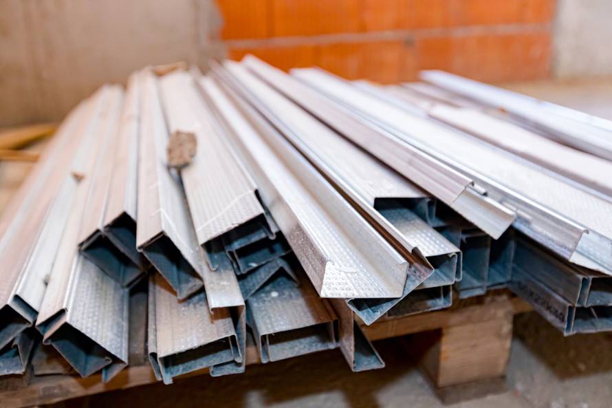 Pile,Of,New,Metal,Profiles,For,Drywalls,Arranged,On,Wooden