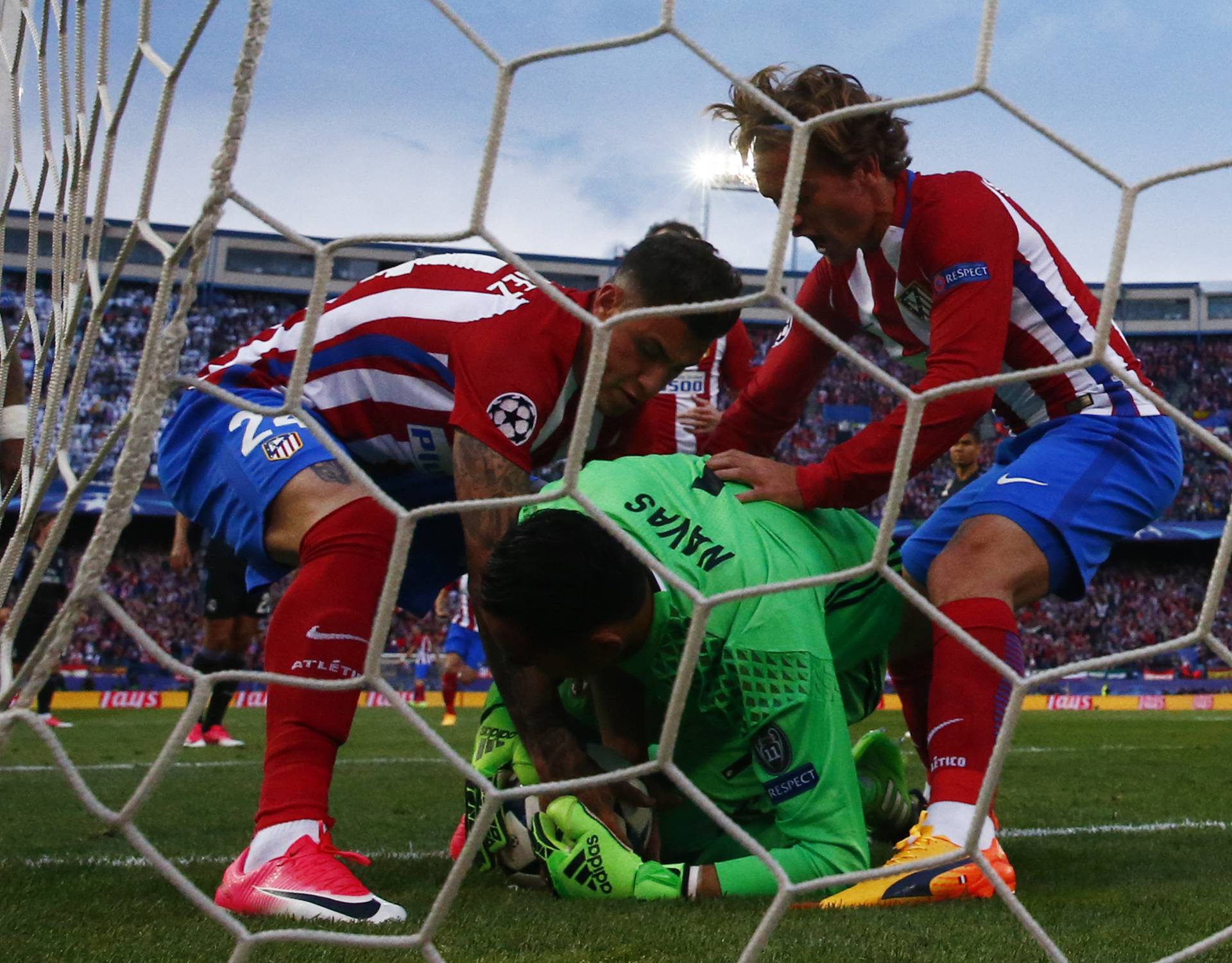 Atletico Madrid's Antoine Griezmann and Jose Gimenez retrieve the ball from Real Madrid's Keylor Navas after Saul Niguez (not pictured) scores their first goal