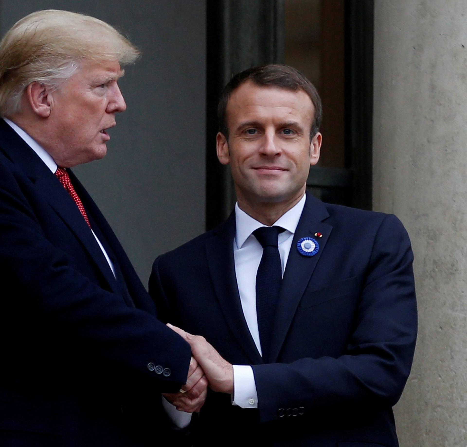 FILE PHOTO: French President Emmanuel Macron shakes hands with U.S. President Donald Trump after a meeting at the Elysee Palace in Paris