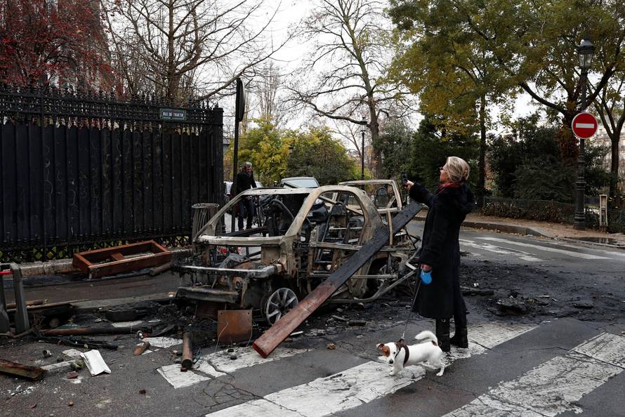 Vandalized cars are seen on a street the morning after clashes with protesters wearing yellow vests, a symbol of a French drivers' protest against higher diesel taxes, in Paris