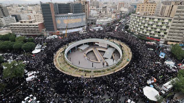 People gather to mourn for the death of the late Iran's President Ebrahim Raisi, in Tehran