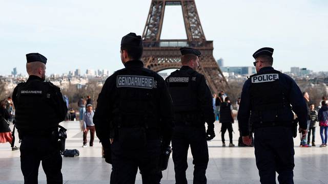 French police and gendarmes patrol near the Eiffel Tower in Paris