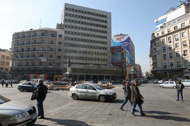 People walk in Damascus