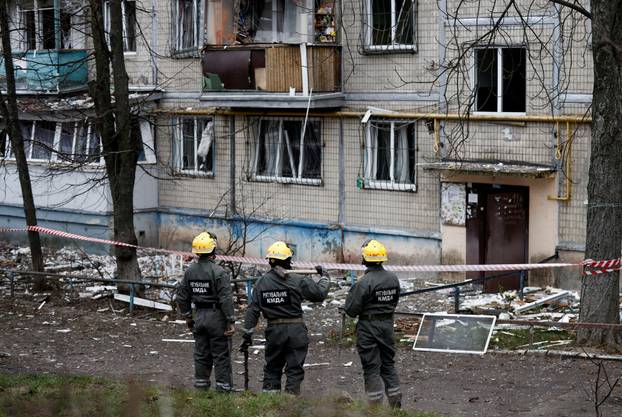 Emergency responders work at the site of a Russian drone strike on an apartment building, in Kyiv