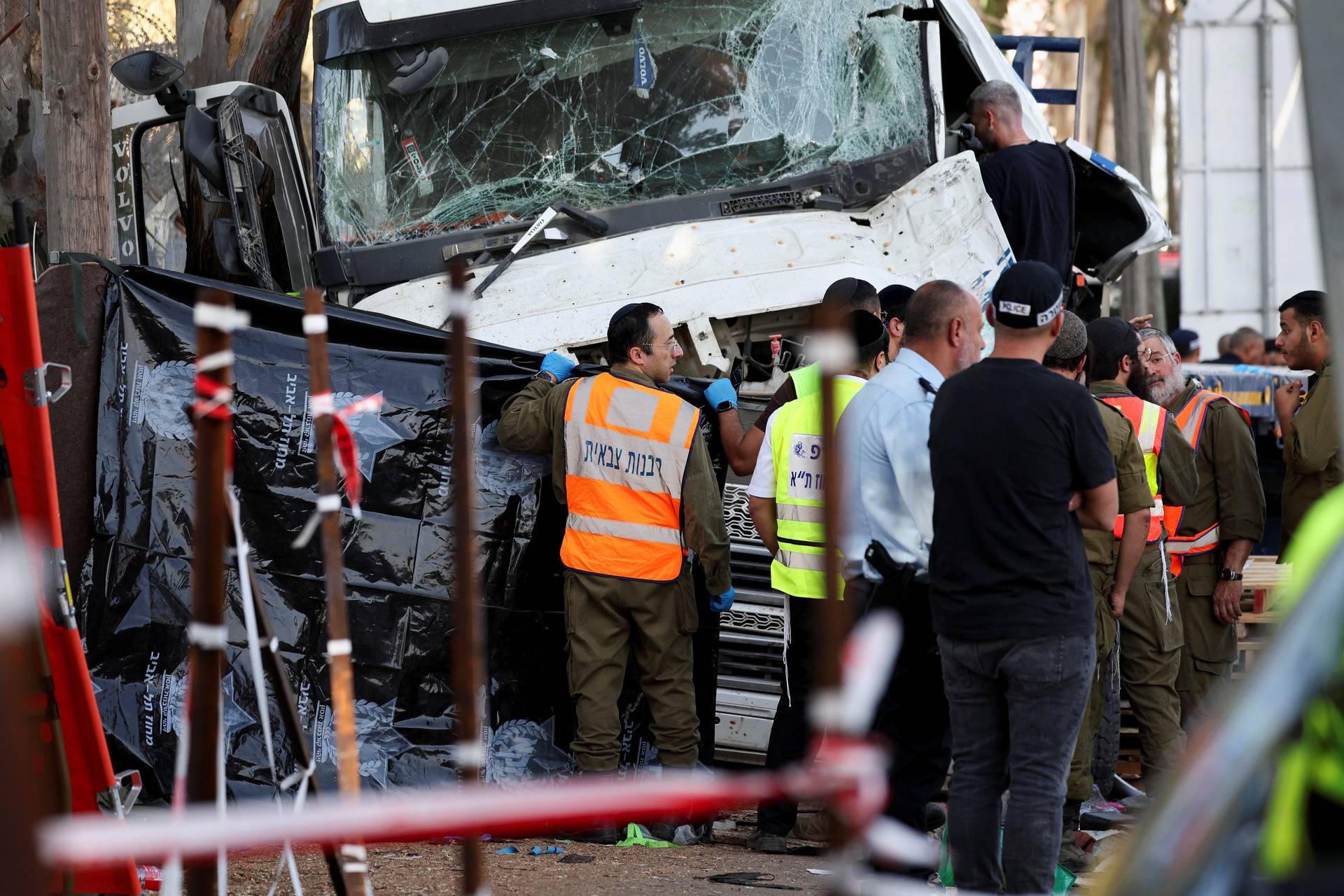 Israeli emergency services work at the scene where a truck rammed into pedestrians at a bus stop, in Ramat Hasharon