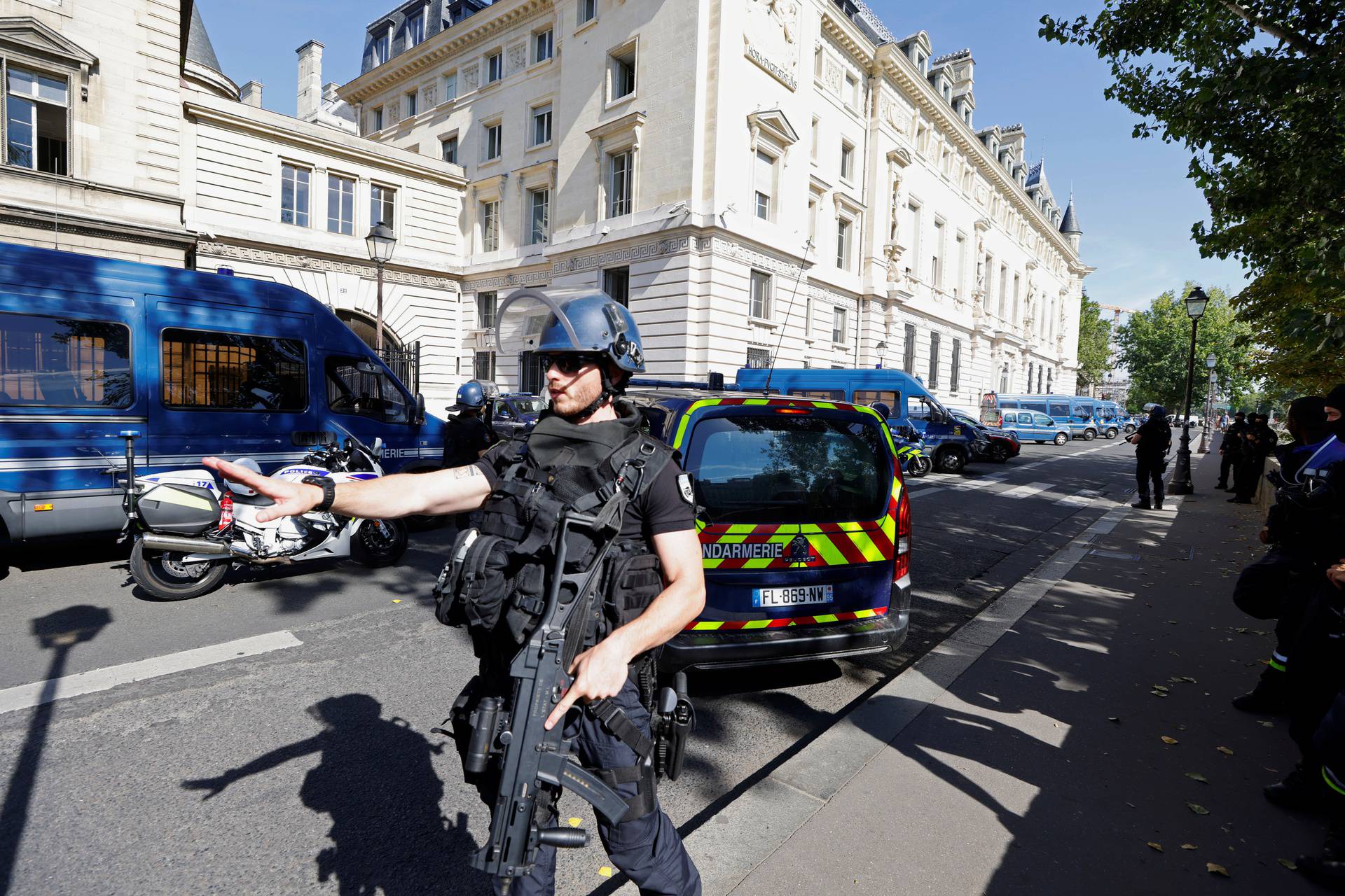 French police forces are seen near the Paris courthouse on the Ile de la Cite in Paris