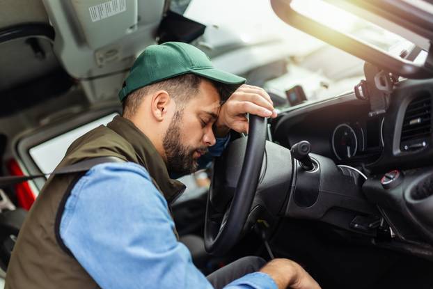 Truck diver feeling tired during the ride.