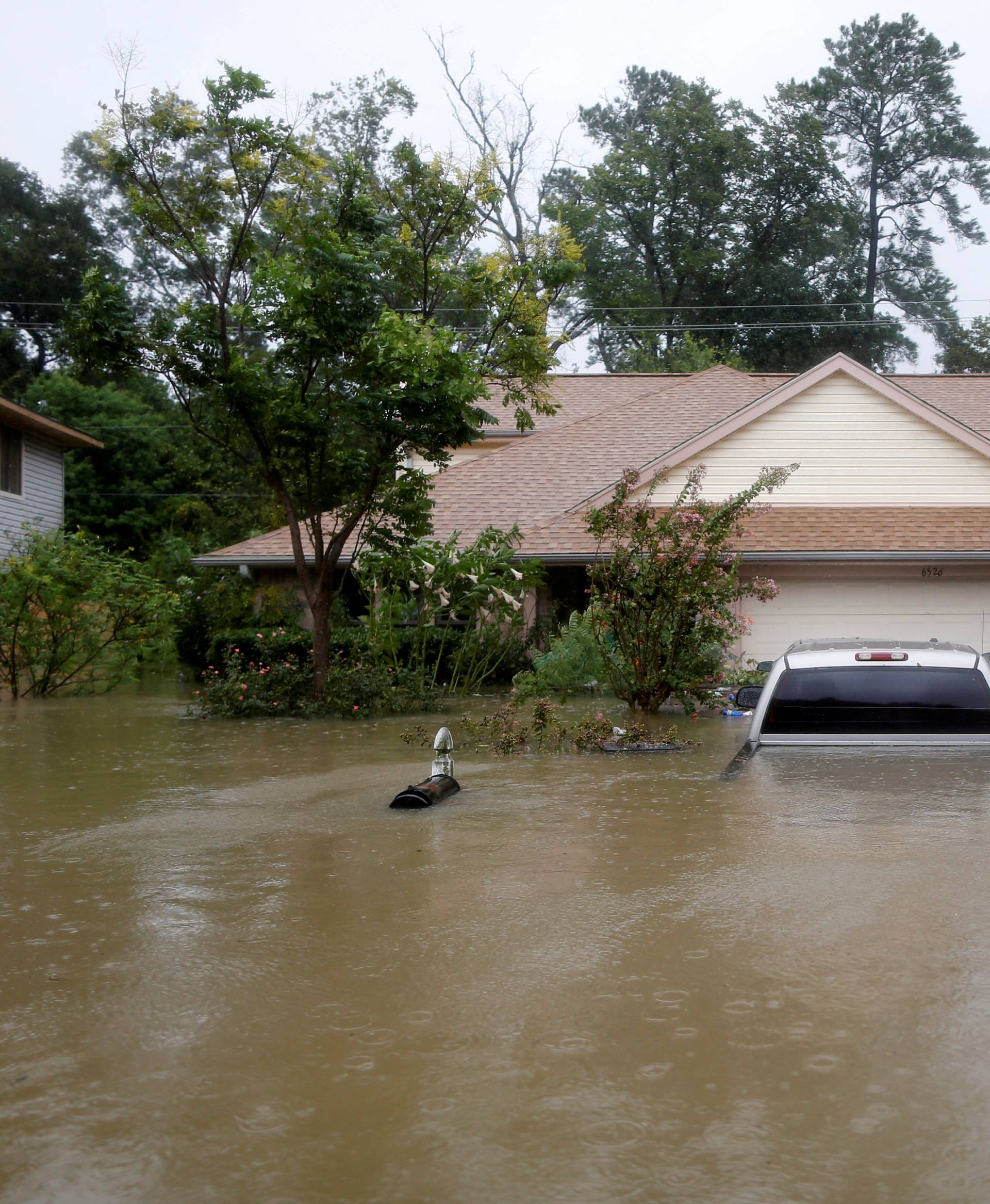 FILE PHOTO:    Houses and cars are seen partially submerged by flood waters from tropical storm Harvey in east Houston