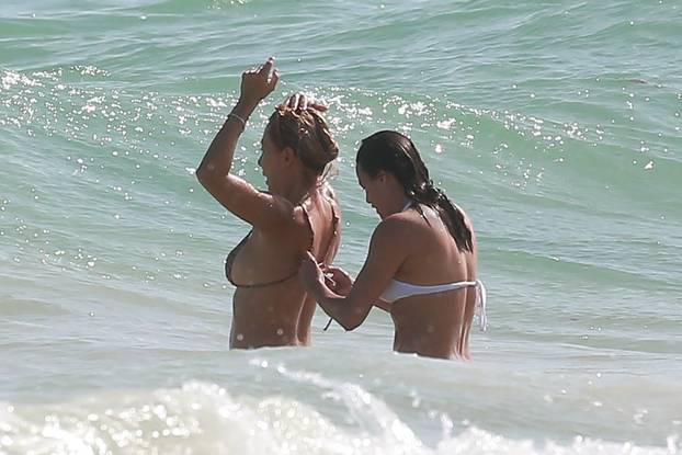 *EXCLUSIVE* Michelle Rodriguez shows a bit too much on white bikini while vacationing with a mystery blonde in Tulum