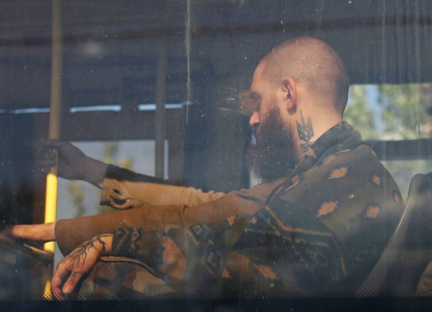 Buses carrying service members of Ukrainian forces who have surrendered after weeks holed up at Azovstal steel works leave Mariupol