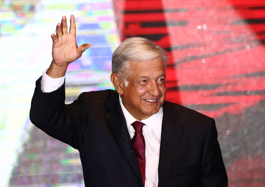 Presidential candidate Andres Manuel Lopez Obrador waves as he addresses supporters after polls closed in the presidential election, in Mexico City