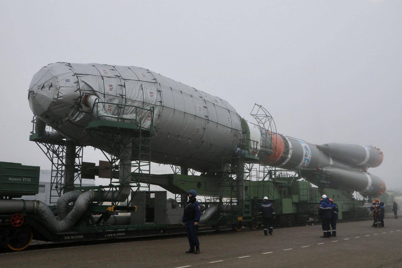 A Soyuz rocket booster with satellites of British firm OneWeb is transported to a launchpad at the Baikonur Cosmodrome