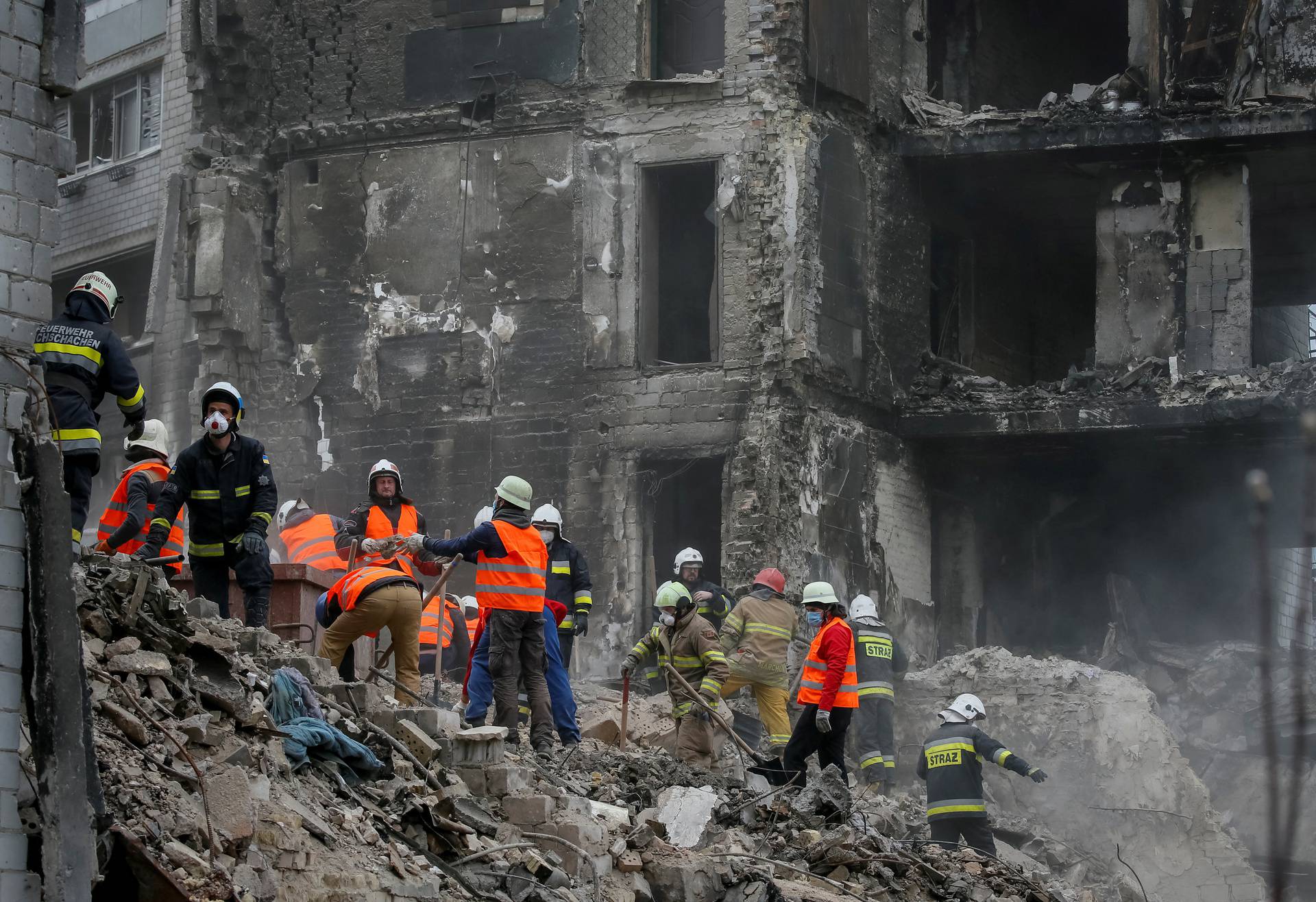 Rescuers work among remains of residential building destroyed by Russian shelling in Borodyanka