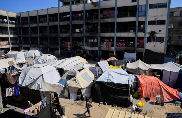 Palestinians displaced by the Israeli military offensive shelter in tents in a UNRWA school, in Khan Younis, in the southern Gaza Strip