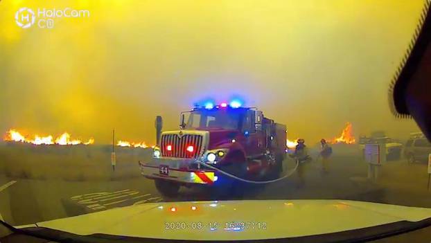 Social media video grab of firefighters driving to safety from massive Loyalton Fire in Chilcoot, California