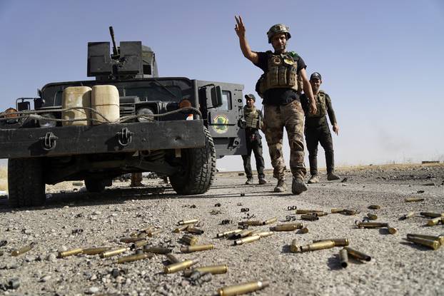 A member of Iraqi security forces gestures at Bartila in the east of Mosul during an attack on Islamic State militants in Mosul