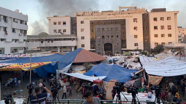 FILE PHOTO: Smoke rises as displaced Palestinians take shelter at Al Shifa hospital, amid the ongoing conflict between Hamas and Israel, in Gaza City