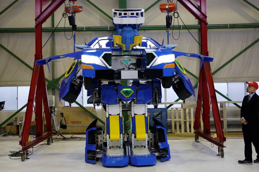 New transforming robot called "J-deite RIDE" that transforms itself into a passenger vehicle, developed by Brave Robotics Inc, Asratec Corp and Sansei Technologies Inc, demonstrates during its unveiling at a factory near Tokyo