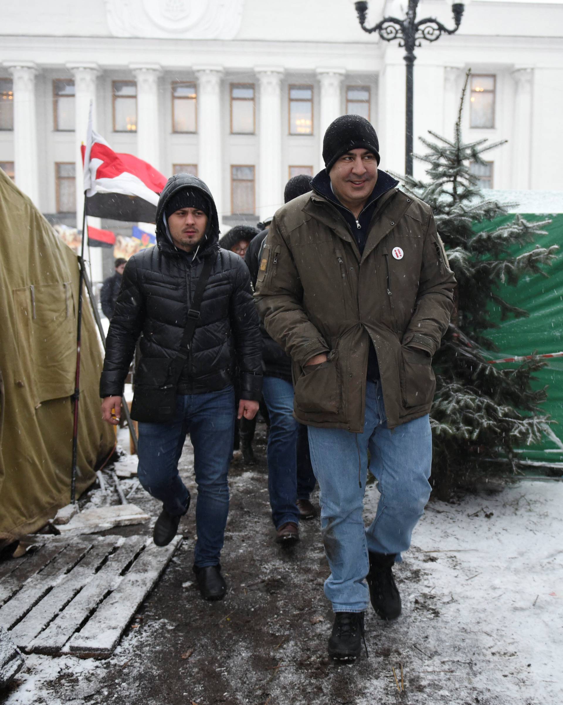 Former Georgian President Mikheil Saakashvili walks past tents set up in front of the Parliament building in Kiev