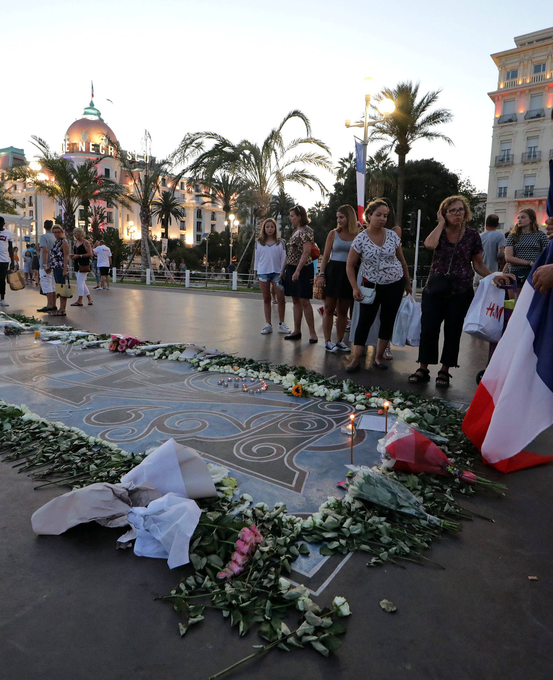 A man prays at a memorial on the Promenade des Anglais as part of the commemorations of last year's July 14 Bastille Day fatal truck attack in Nice