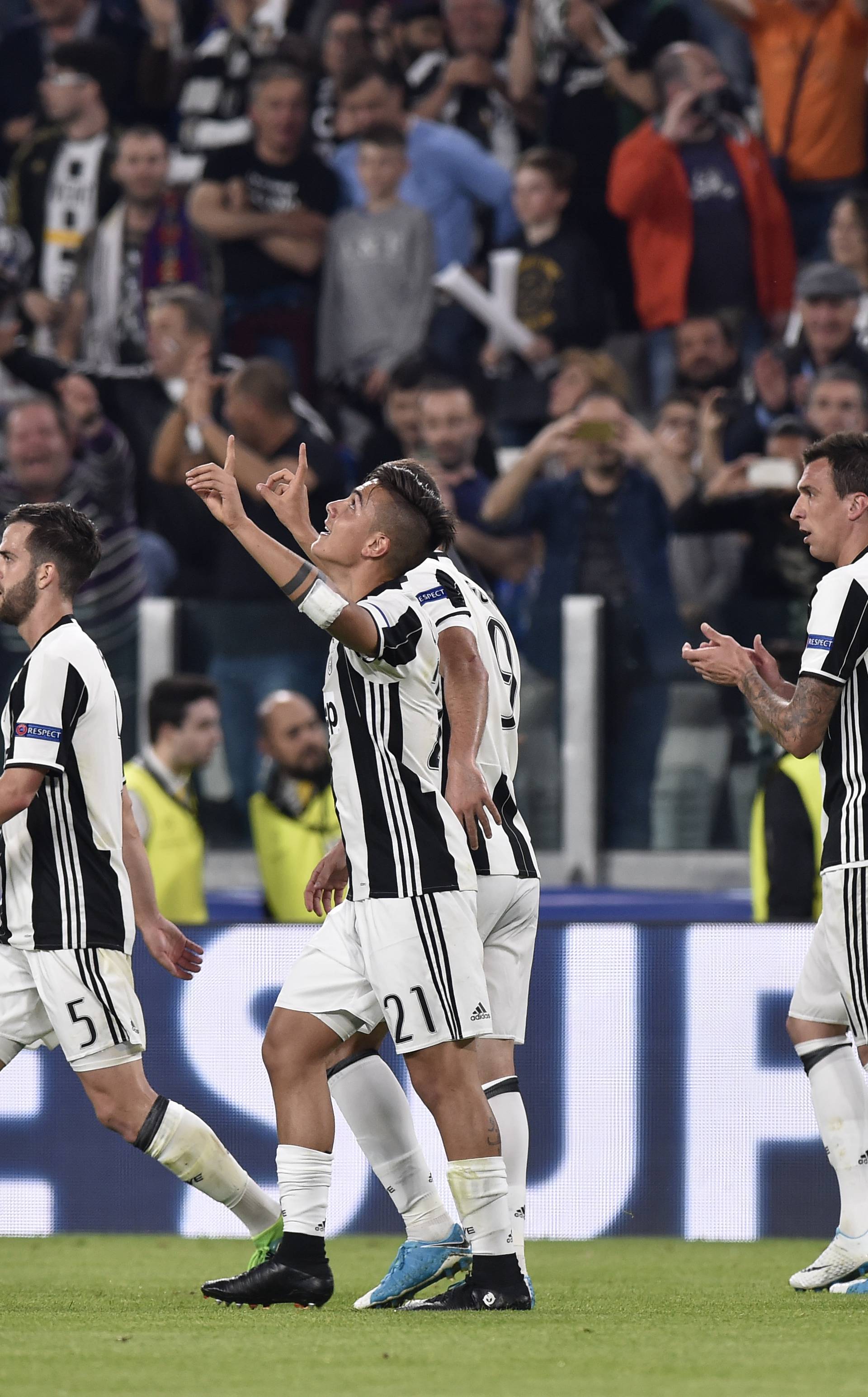 Juventus' Paulo Dybala celebrates scoring their second goal with team mates