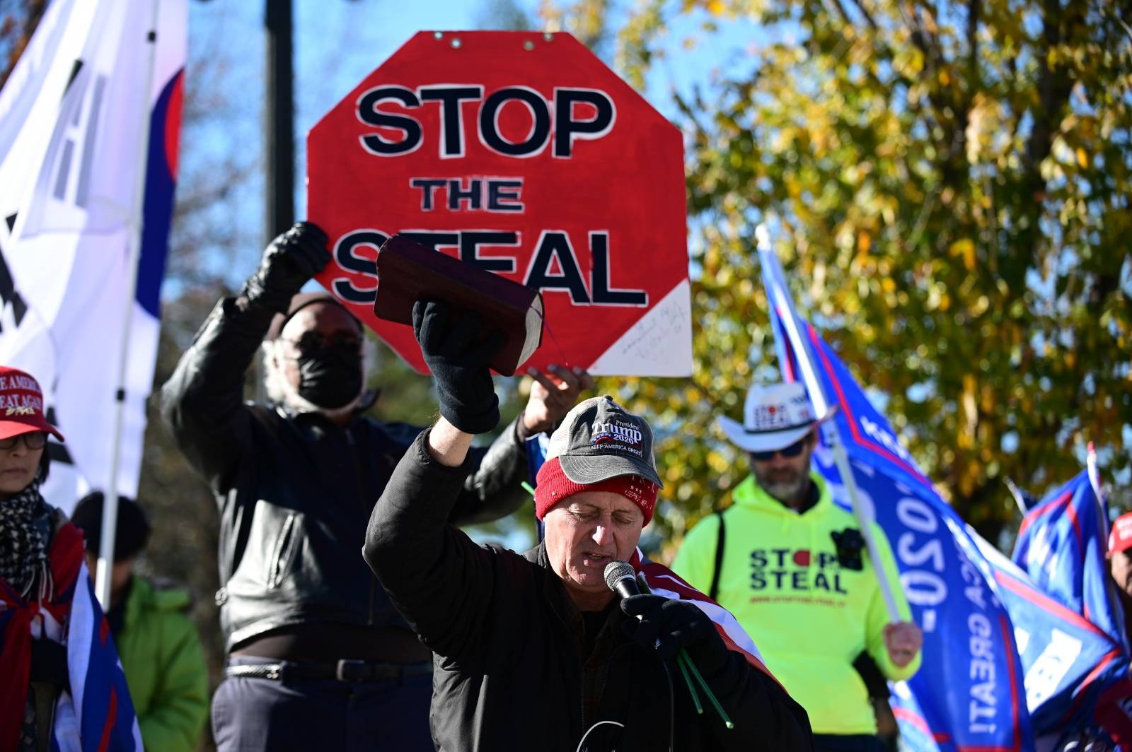 Ted O'Grady holds a Bible as he prays during a "Stop the Steal" protest outside the U.S. Supreme Court in support of U.S. President Donald Trump in Washington