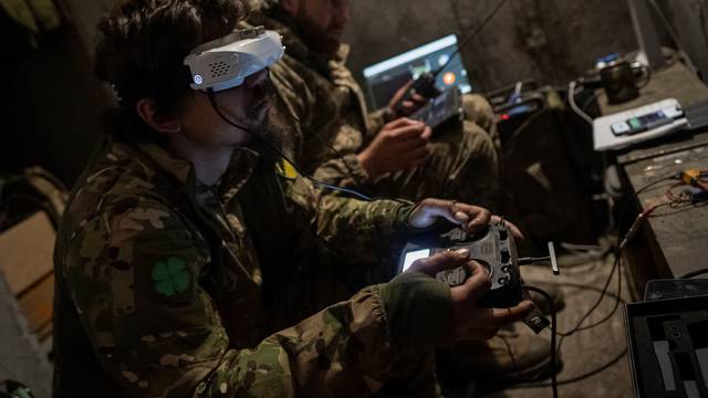 Ukrainian serviceman operate a drone at his position at a front line near a Russian border in a Kharkiv region