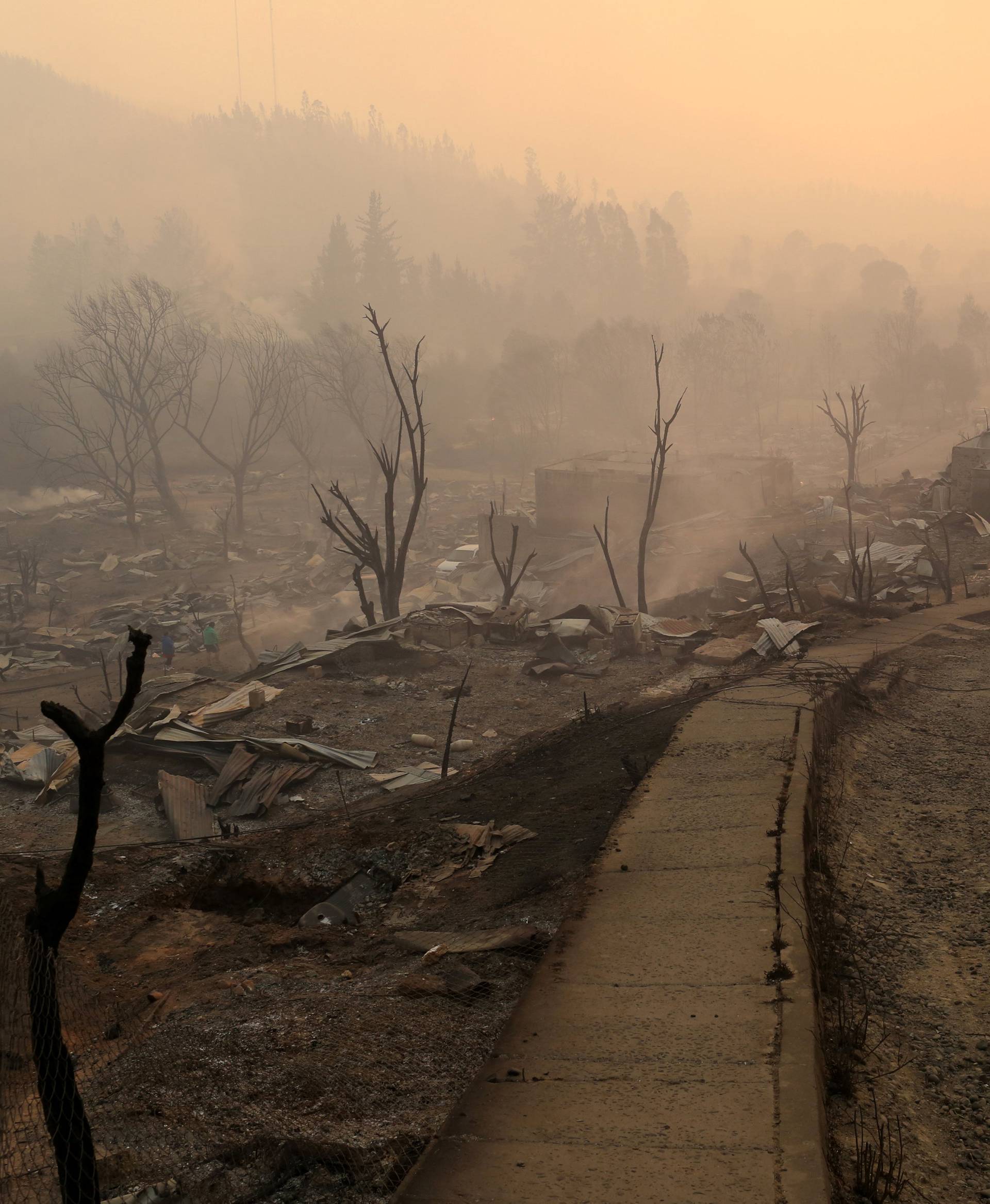The remains of burnt houses are seen as the worst wildfires in Chile's modern history ravage wide swaths of the country's central-south regions, in Santa Olga