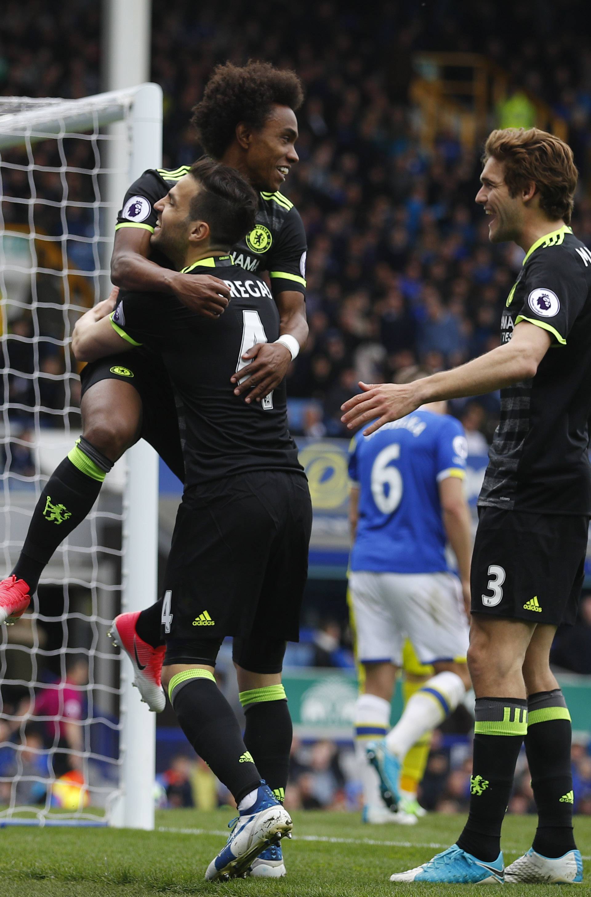 Chelsea's Willian celebrates scoring their third goal with  Cesc Fabregas and Marcos Alonso
