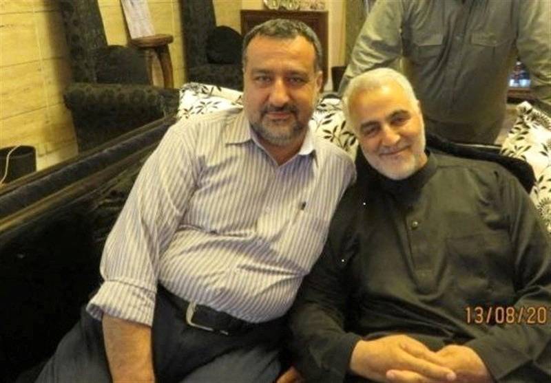 Senior adviser for Iran's Islamic Revolutionary Guard Corps, Sayyed Razi Mousavi, sits next to late Iranian Major-General Qasem Soleimani