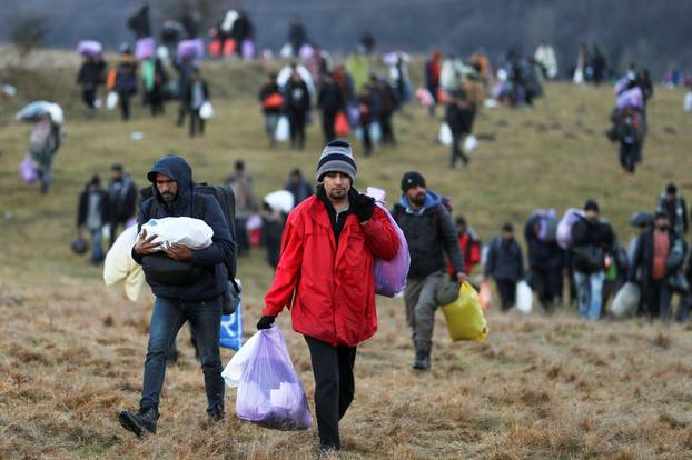 Migrants walk towards the forest after camp "Lipa" was closed, in Bihac