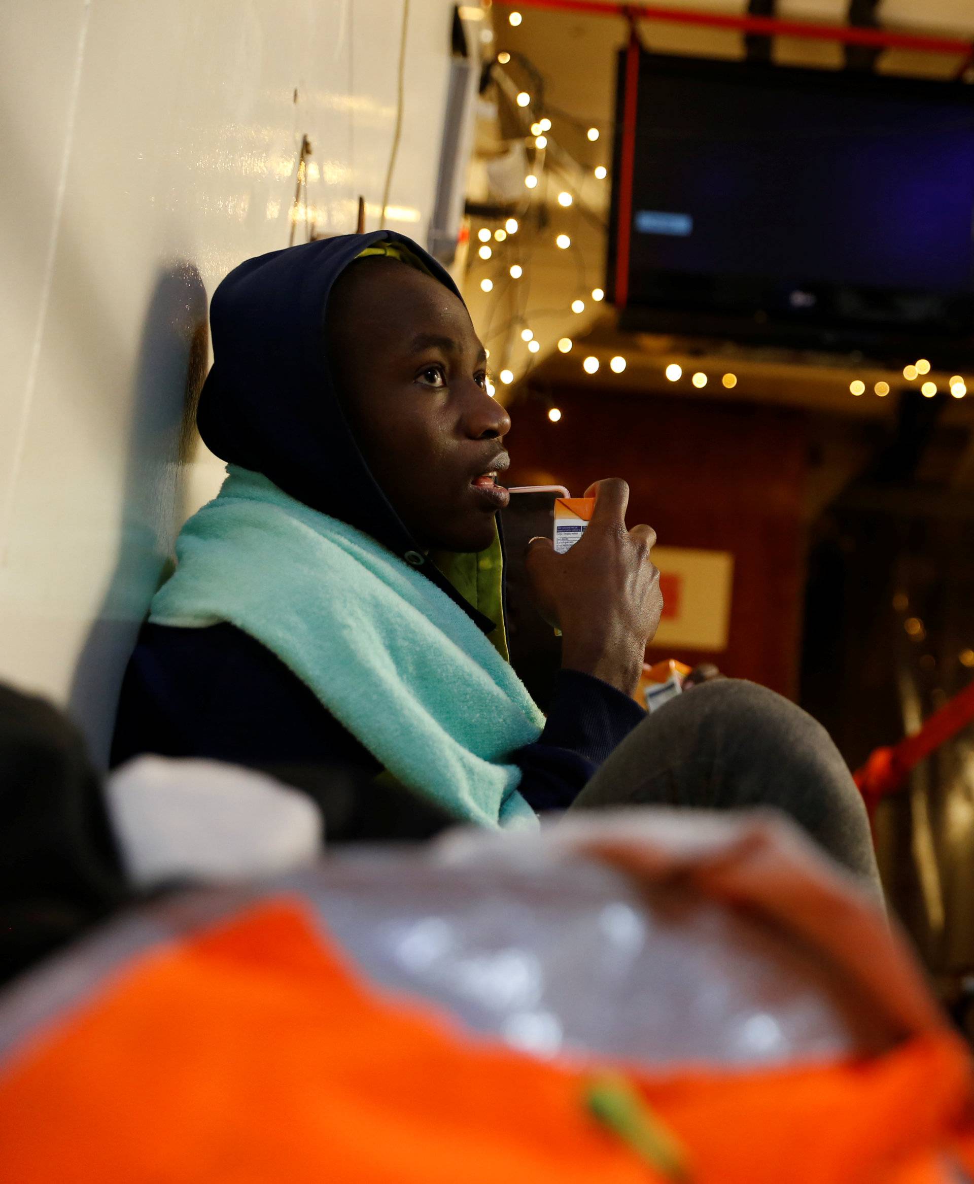 Migrants rest on the migrant search and rescue ship Sea-Watch 3off the coast of Malta in the central Mediterranean