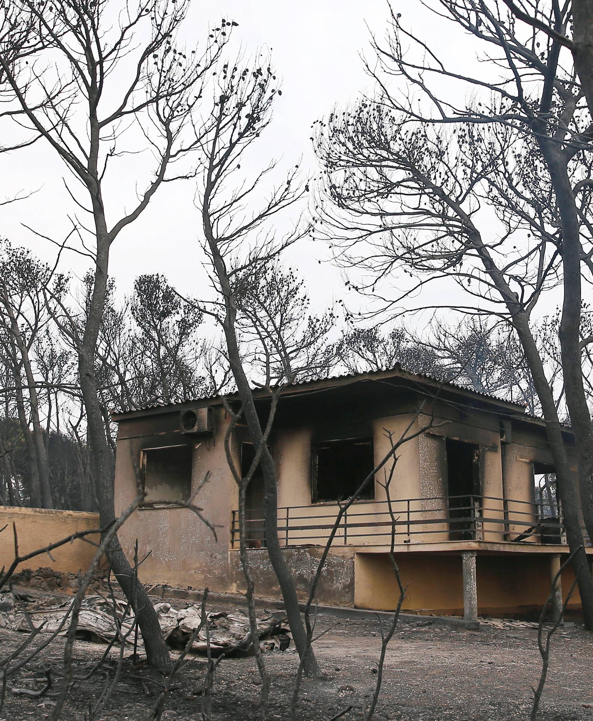 A burned house is seen following a wildfire at the village of Mati, near Athens