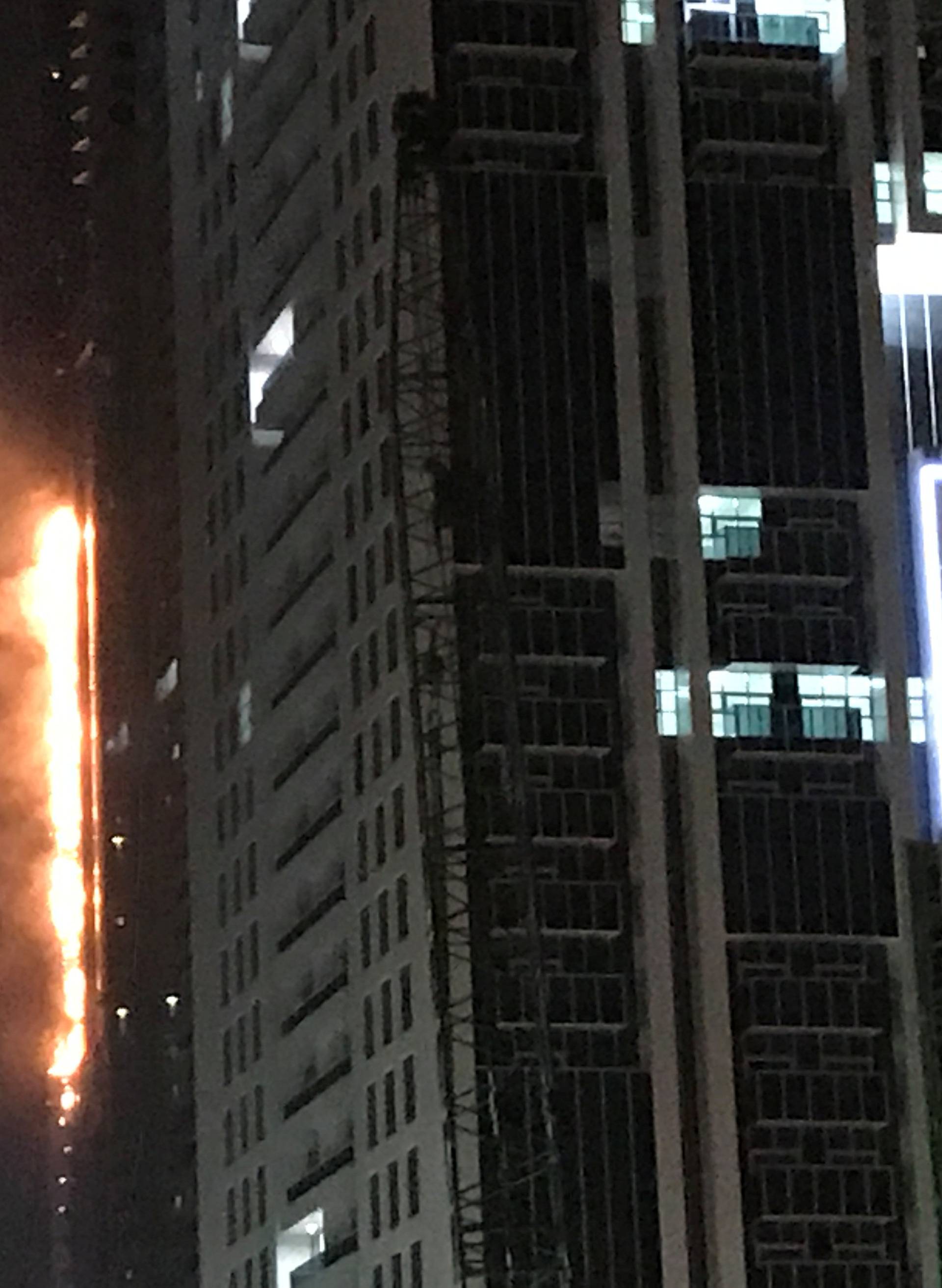 Flames shoot up the side of the Torch tower residential building in the Marina district, Dubai