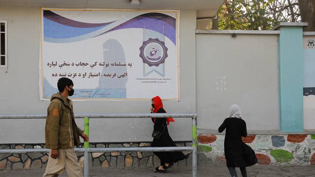 People walk in a street in Kabul