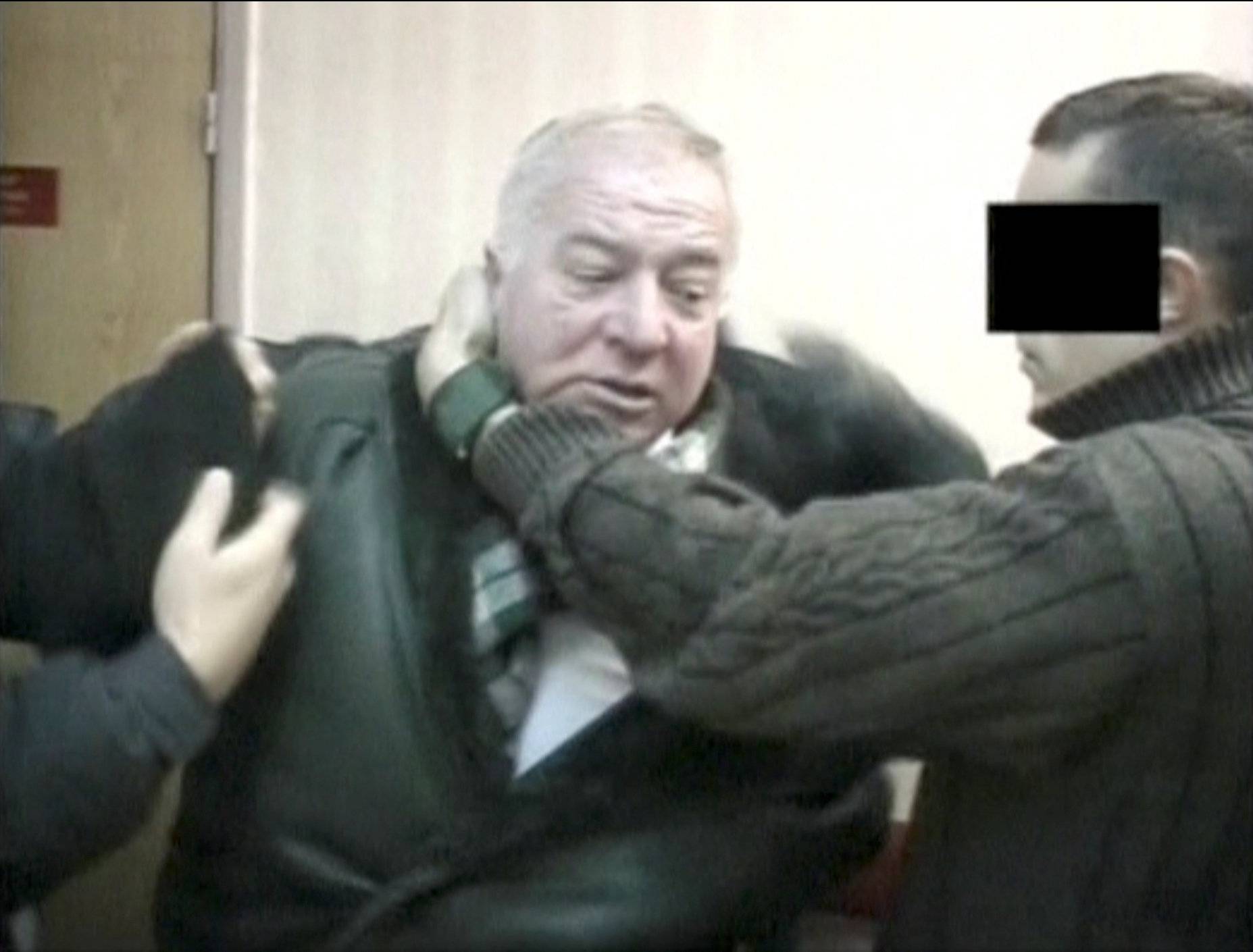 A still image taken from an undated video shows Sergei Skripal, a former colonel of Russia's GRU military intelligence service, being detained by secret service officers in an unknown location.